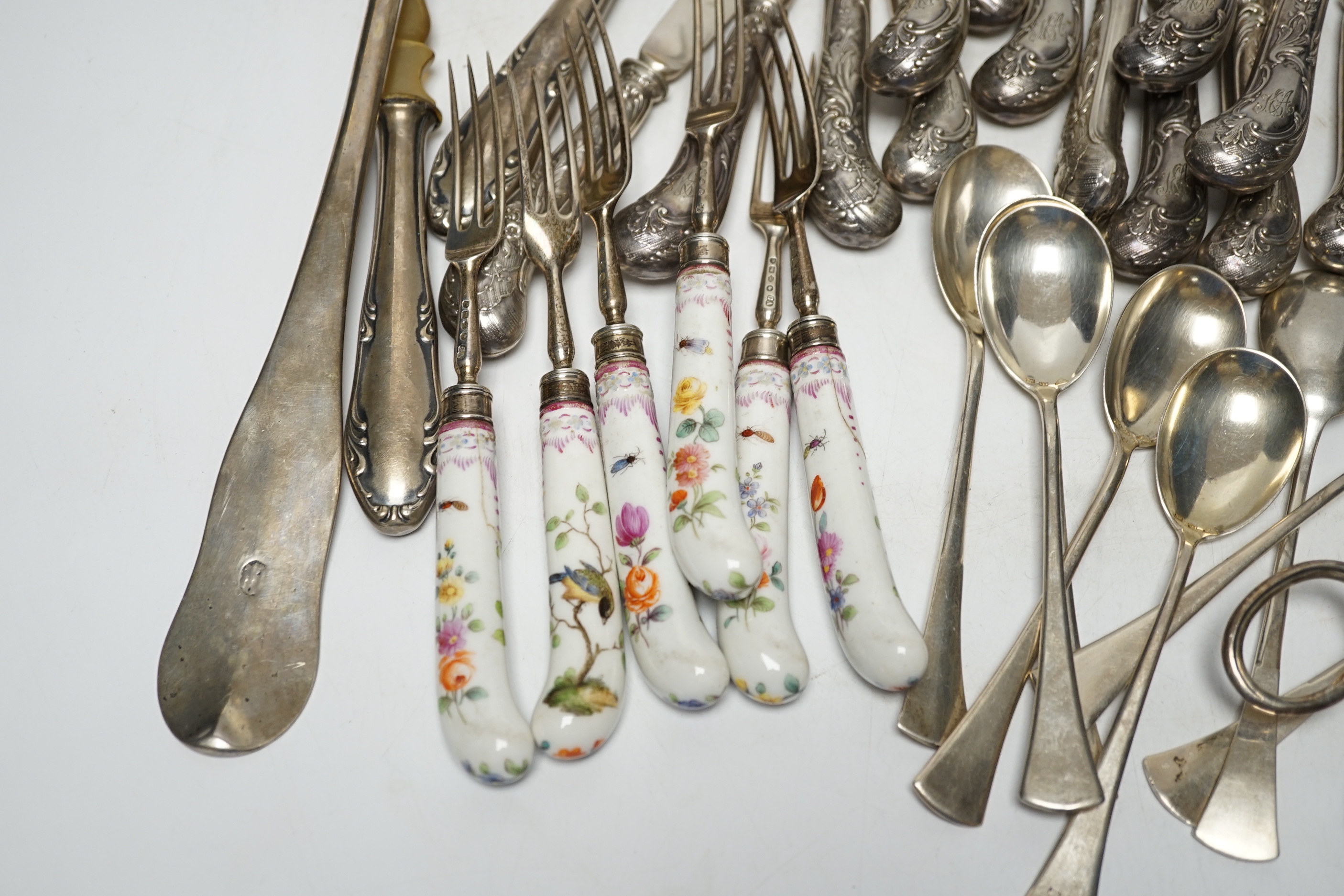 Six Victorian silver dessert forks by George Adams, London, 1880, with Meissen handles, 17.5cm(a.f.), eight 800 standard sorbet spoons, seven pairs of Austro-Hungarian white metal fish eaters, five other continental item